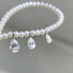 Pear cut teardrop clear moissanite charm crafted in Au750 solid 18K gold with brilliant sparkle.