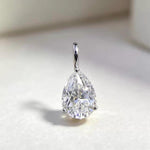 Sparkling pear shaped moissanite pendant charm in solid 18K gold for elegant jewelry making.