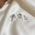 Sparkling square moissanite charm set diagonally in an elegant diamond shape with solid 18K gold.