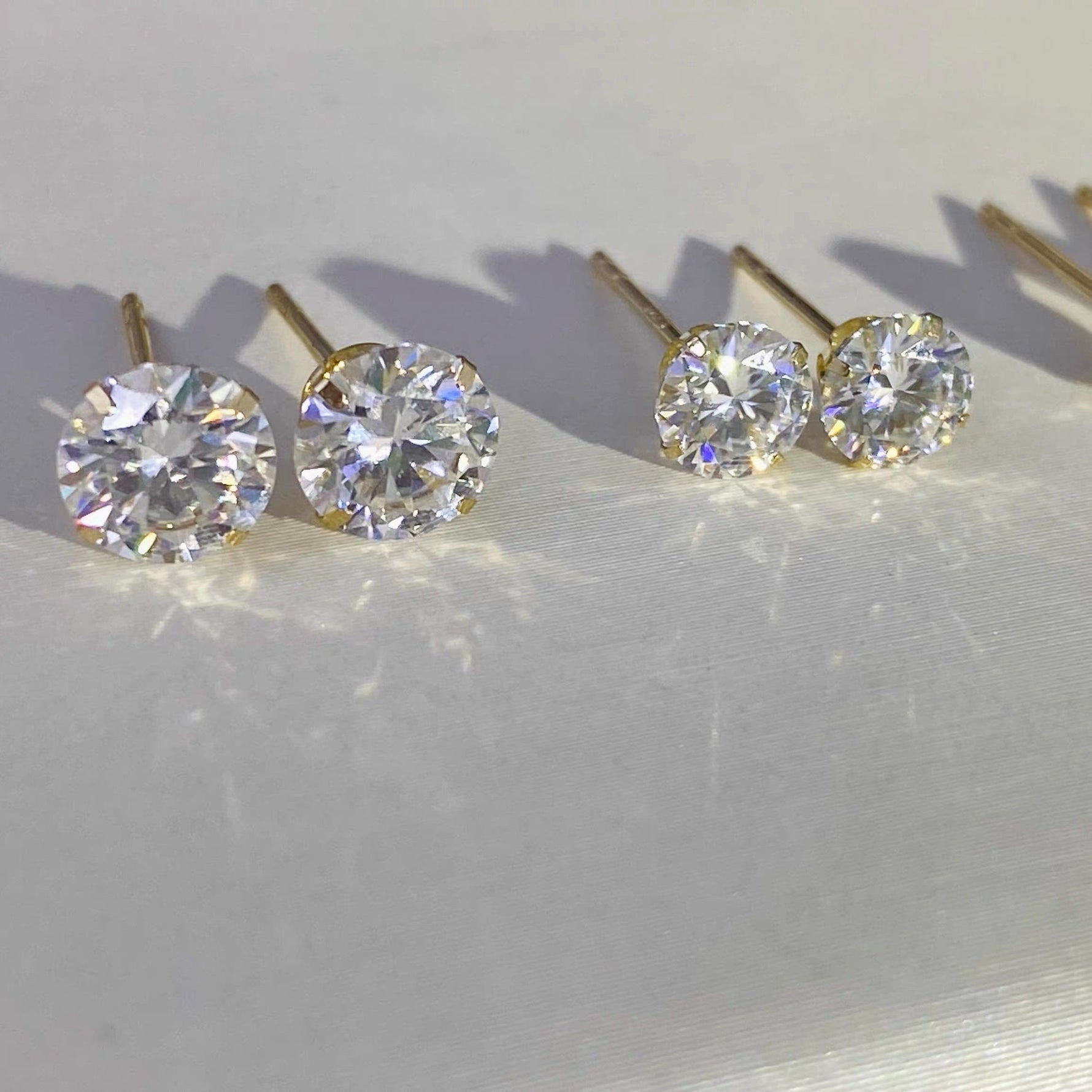 5mm brilliant round moissanite stud earrings crafted in genuine solid 14K gold.