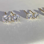 Round moissanite stud earrings in solid 14K gold with classic 4-prong settings and brilliant sparkle.