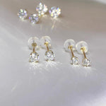 Brilliant clear moissanite 4-prong stud earrings in solid 14K gold, elegant everyday fine jewelry.