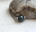 Large dark Tahitian pearl pendant with natural ocean color, mirror luster and detailed vintage silver design.