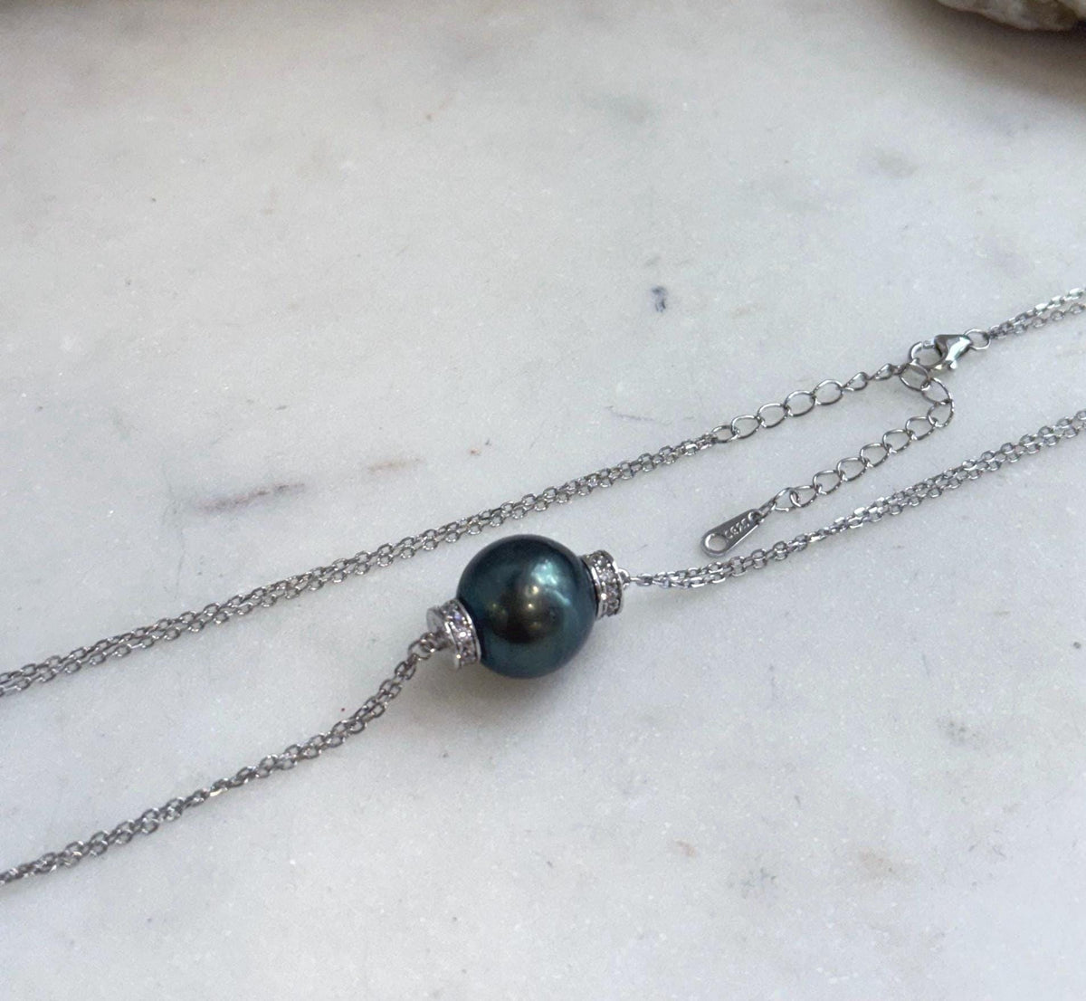 Elegant Tahitian ocean pearl pendant necklace featuring a lustrous 12.7mm pearl in a vintage silver setting.