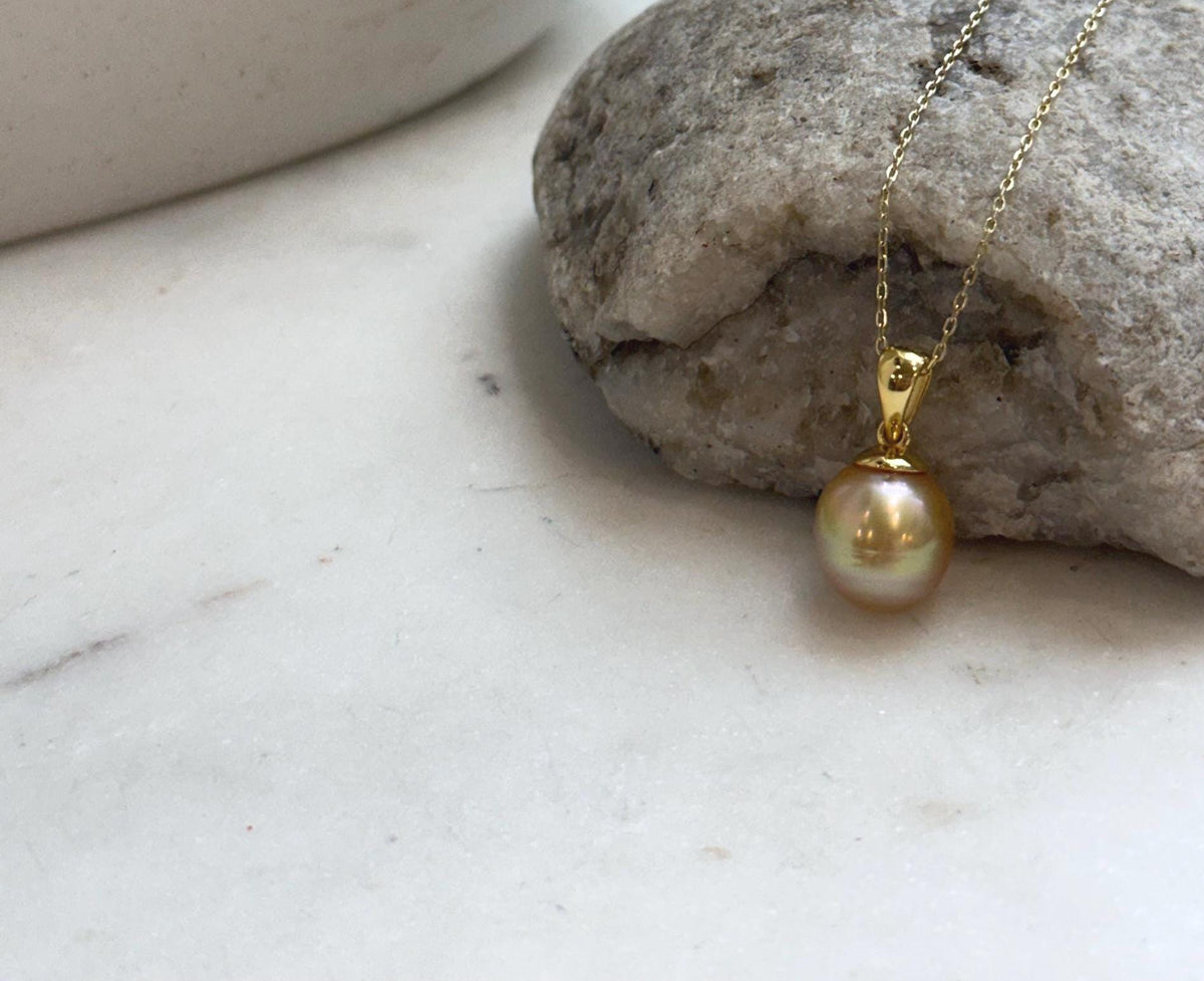 Elegant South Sea golden pearl pendant featuring a genuine saltwater ocean pearl and sterling silver setting