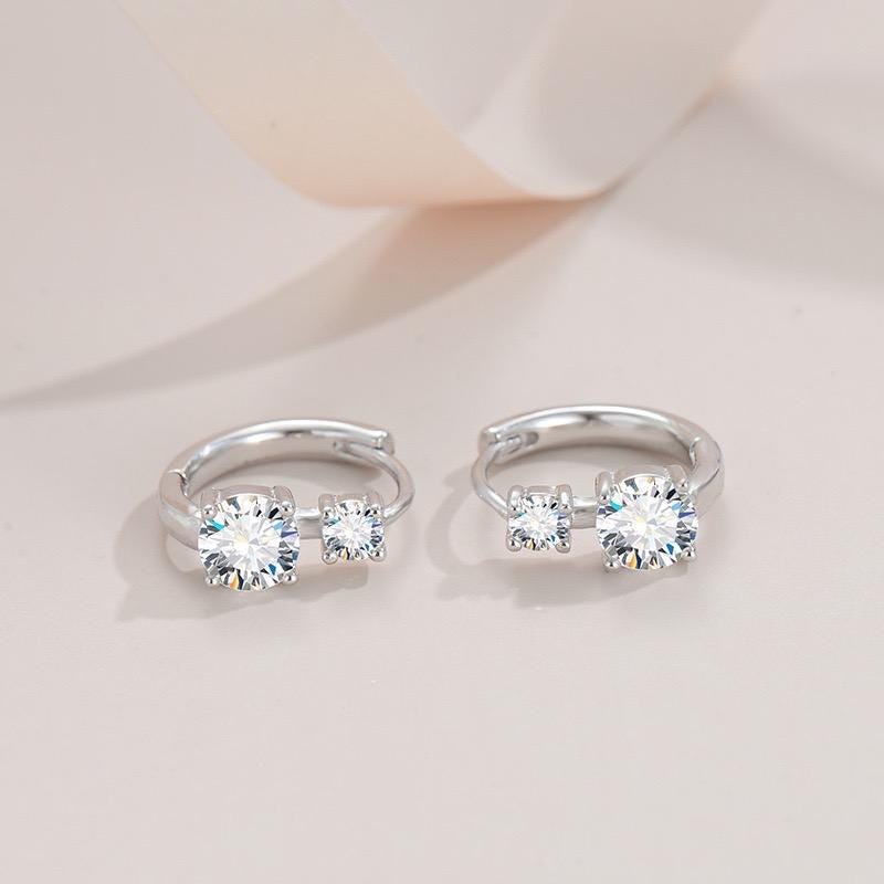 Sparkling four stone moissanite huggie hoop earrings in solid sterling silver