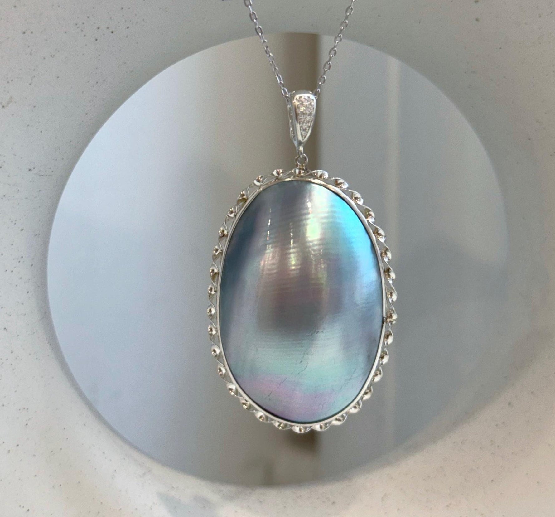 Huge blue iridescent ocean Mabe pearl pendant with extreme mirror luster