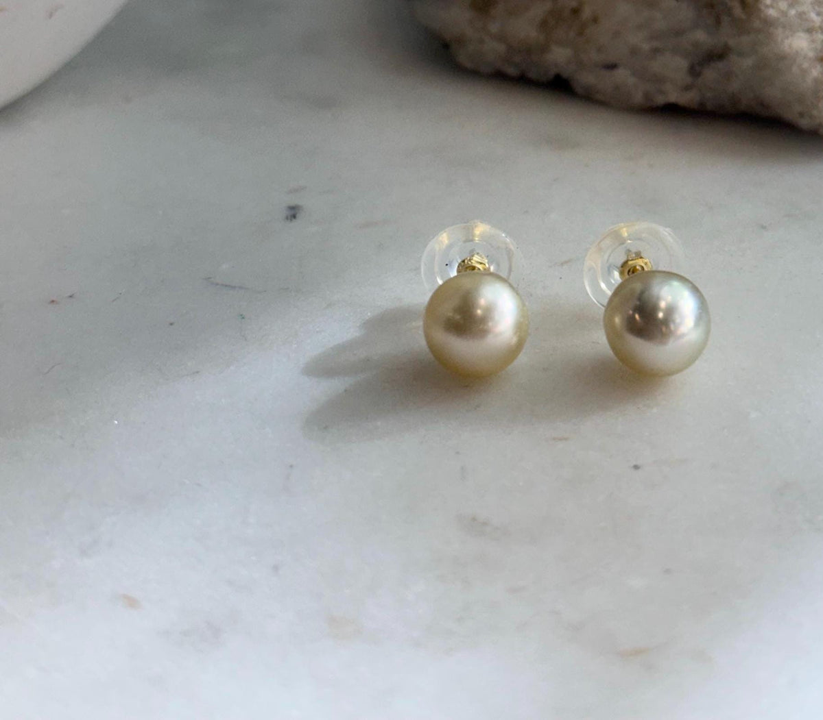 Elegant 9.4mm golden South Sea pearl studs with luminous mirror shine