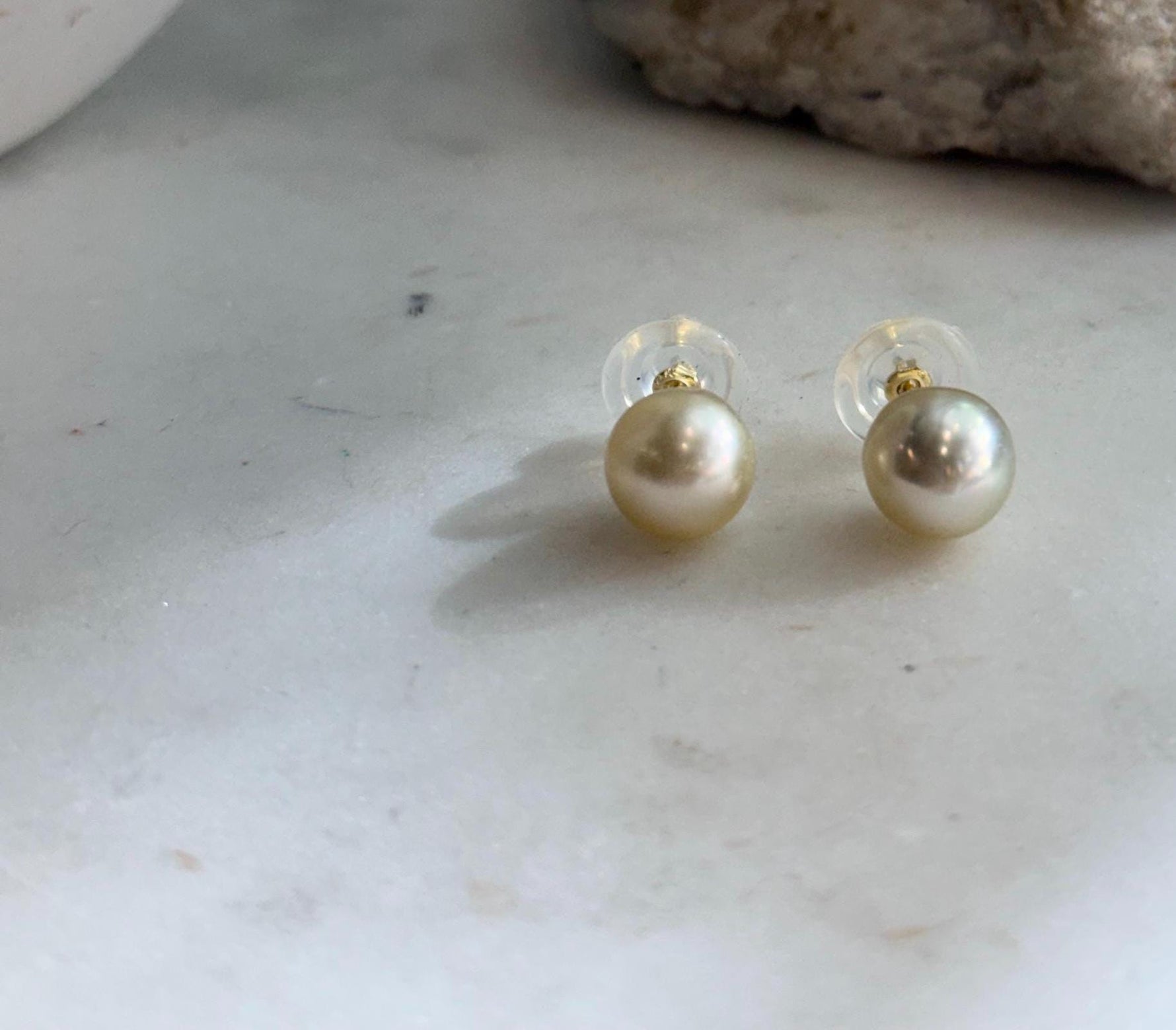 Elegant 9.4mm golden South Sea pearl studs with luminous mirror shine
