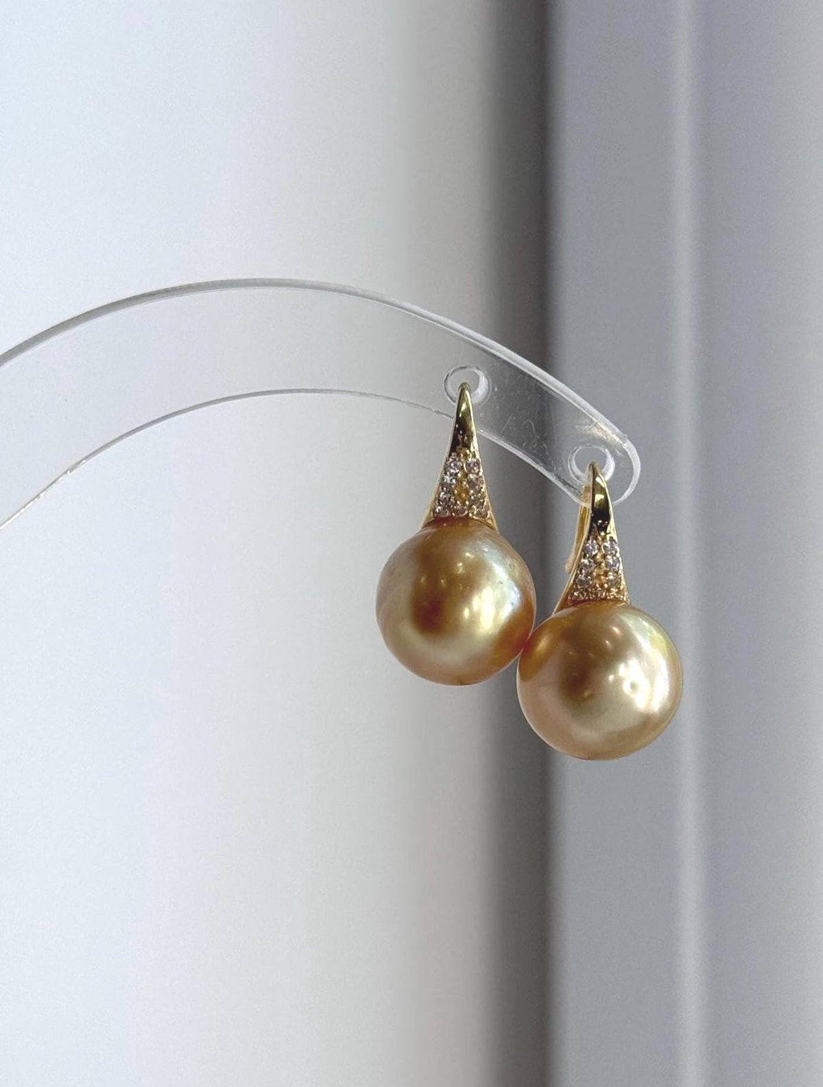 Genuine South Sea golden ocean pearl earrings featuring rich deep gold color and extreme reflective luster.