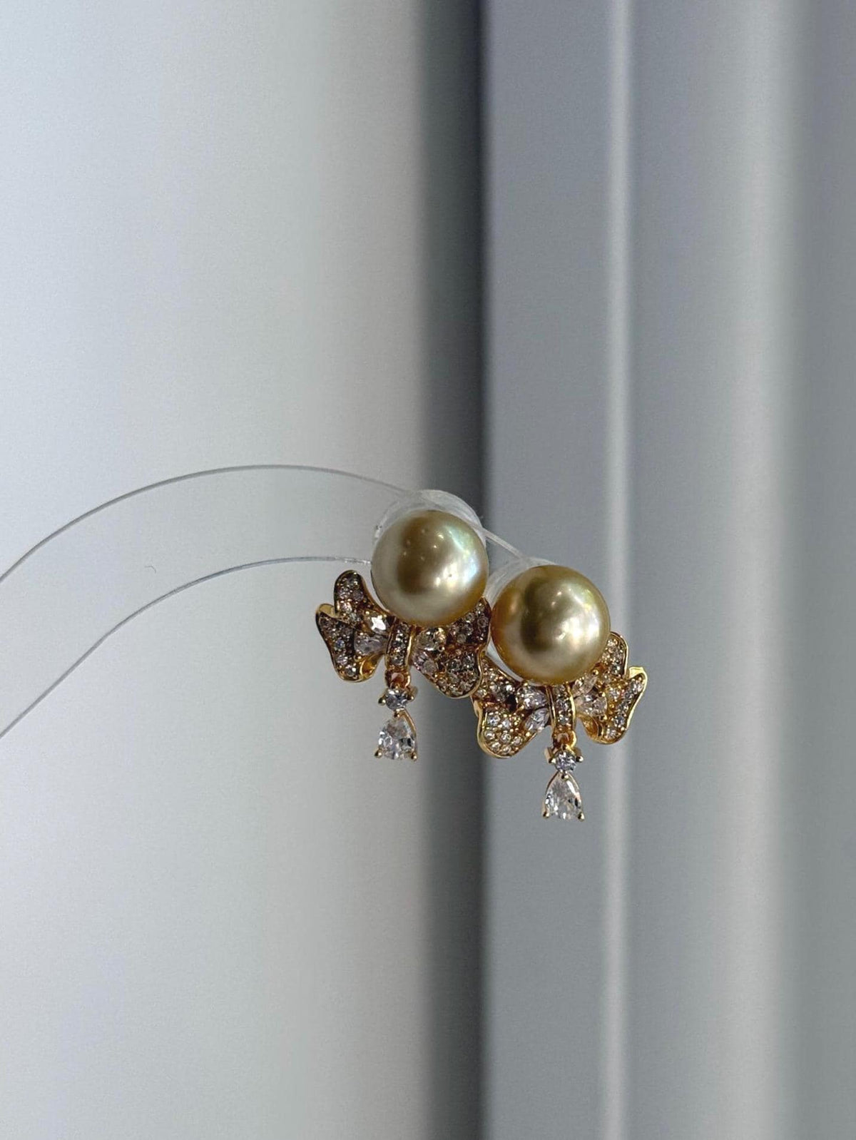 South Sea deep tea golden pearl stud earrings with S925 silver earring jackets and mirror luster.