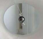 Minimalist Tahitian pearl necklace featuring a 12.3mm round ocean pearl