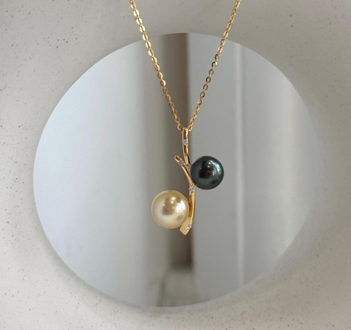 Two color saltwater pearl pendant featuring Tahitian and golden South Sea pearls