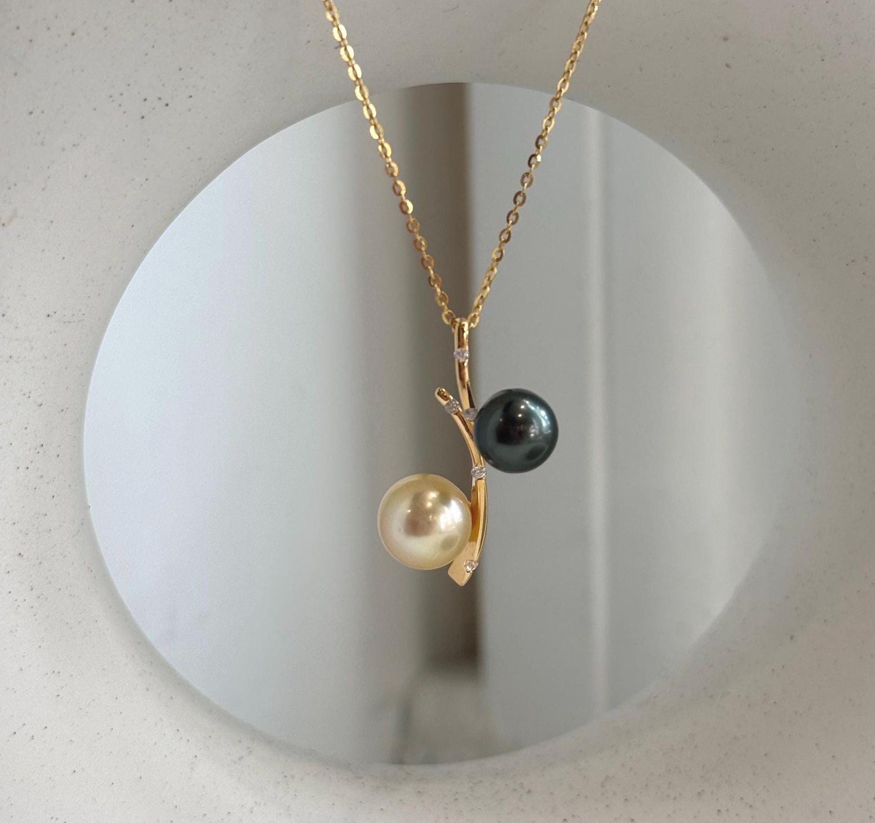 Two color saltwater pearl pendant featuring Tahitian and golden South Sea pearls