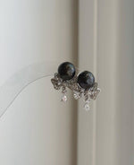 Mirror luster Tahitian black pearl earrings with elegant silver accents