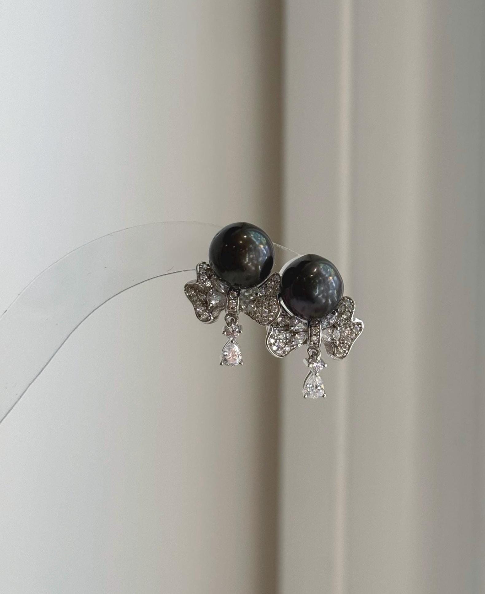 Mirror luster Tahitian black pearl earrings with elegant silver accents
