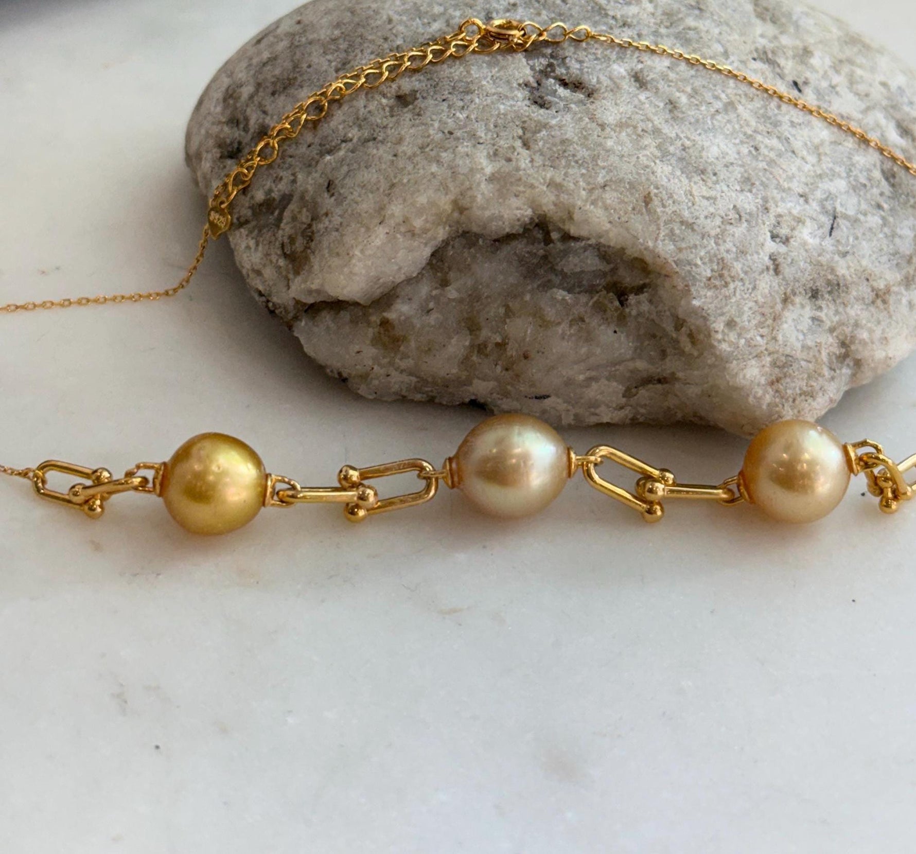 Minimalist three pearl necklace featuring radiant golden South Sea pearls