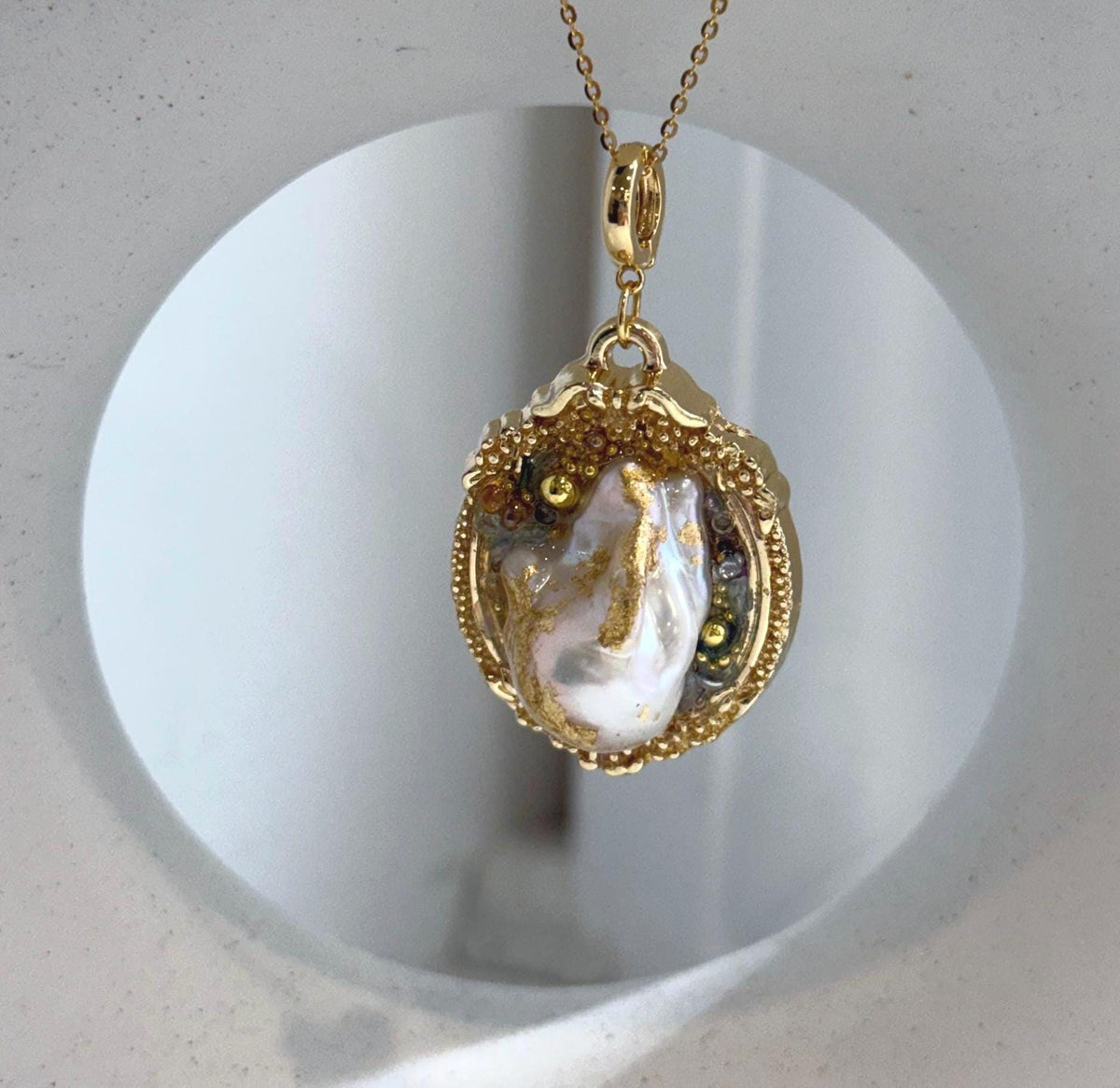 Genuine white iridescent freshwater baroque pearl 2-in-1 brooch and pendant in an elegant vintage design.