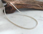 Delicate white pearl necklace featuring Top 5A quality pearls with exceptional shine and 18K gold hardware.