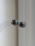 Genuine saltwater Tahitian pearl earrings with playful cat design and vivid peacock green overtones.