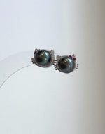 Tahitian peacock pearl cat earrings with metallic mirror reflections and sterling silver details.