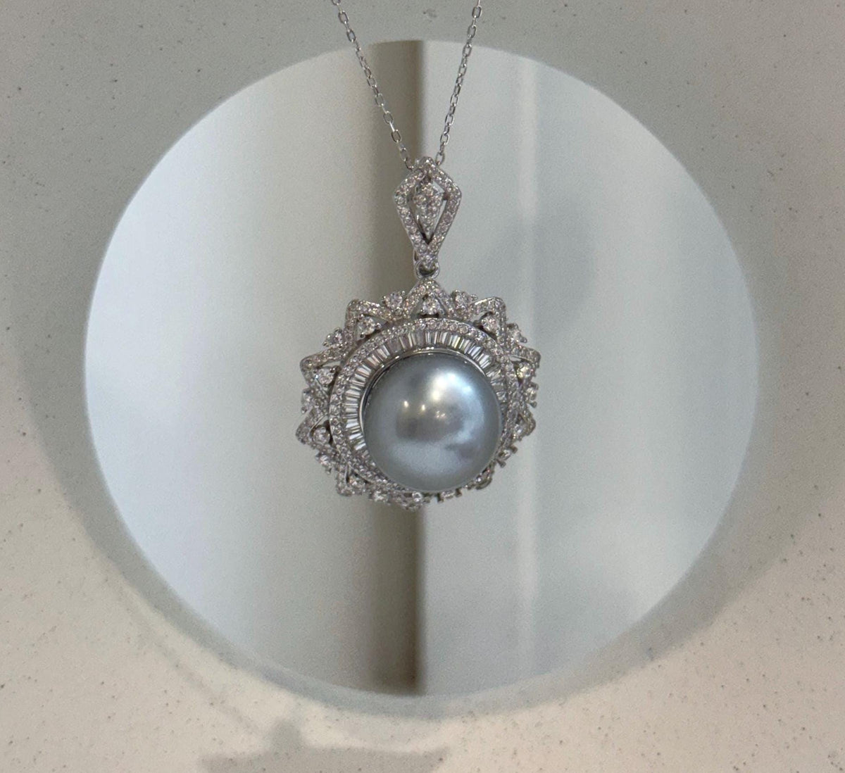 Rare oversized Tahitian pearl pendant chain set with natural silver color and intense reflective shine.