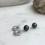 Genuine Tahitian saltwater pearl earrings featuring rich hunter green color and elegant sterling silver floral jackets.