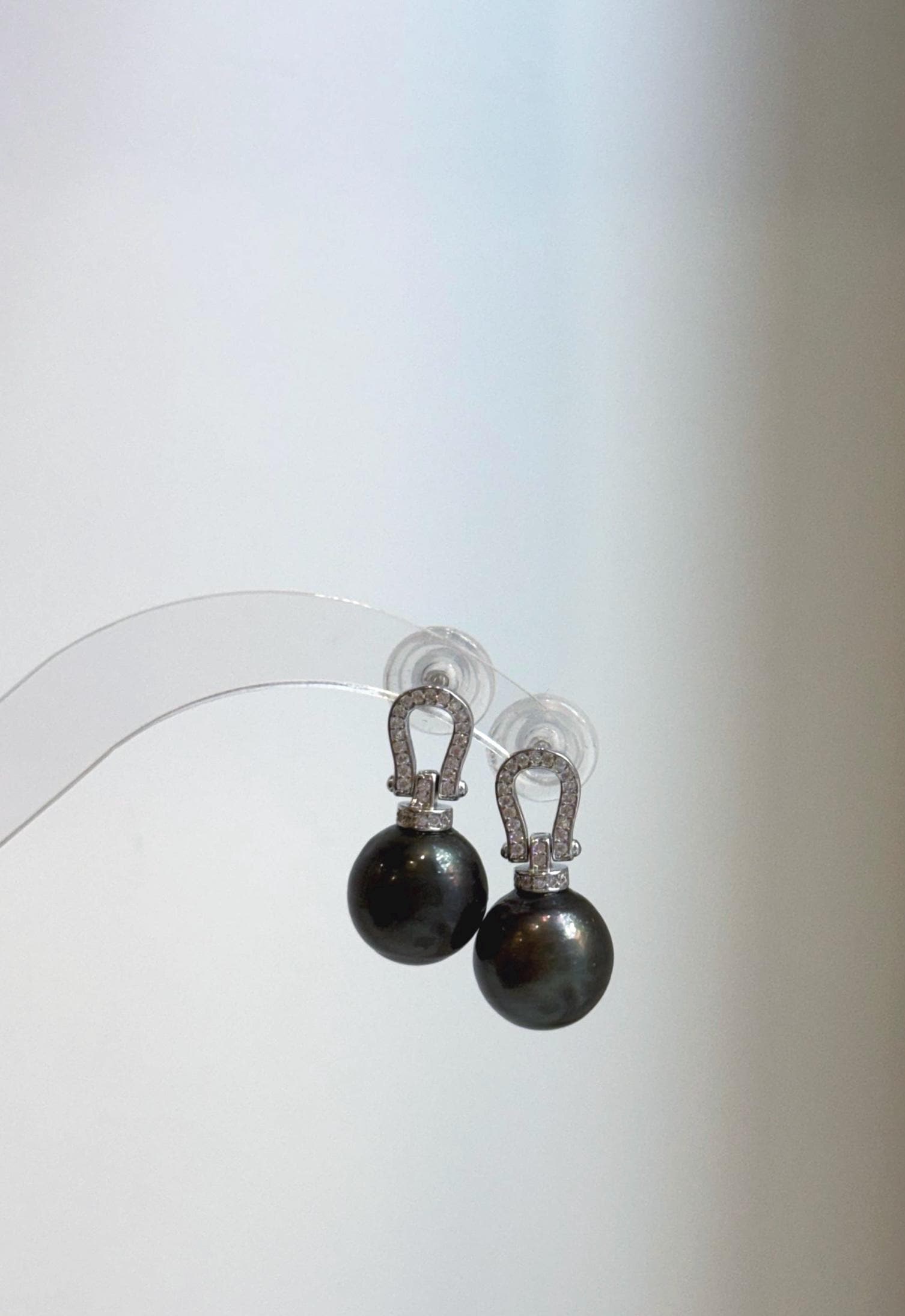 Genuine saltwater Tahitian pearl earrings featuring rich peacock and hunter green overtones with mirror-like luster.