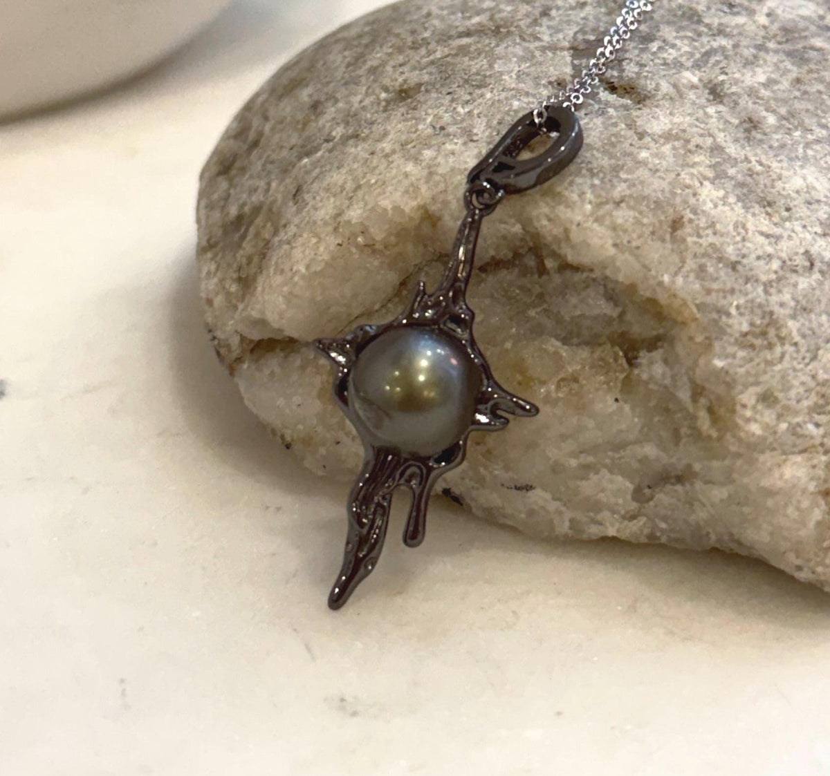 Genuine Tahitian black ocean pearl pendant with artistic molten lava design