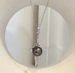 Tahitian peacock pearl lava pendant with extreme luster and copper setting