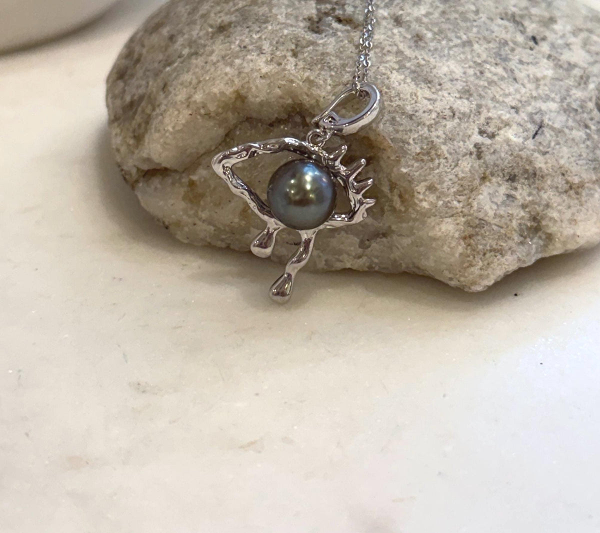 Unique Tahitian pearl eye pendant with extreme luster and detailed copper jewelry design
