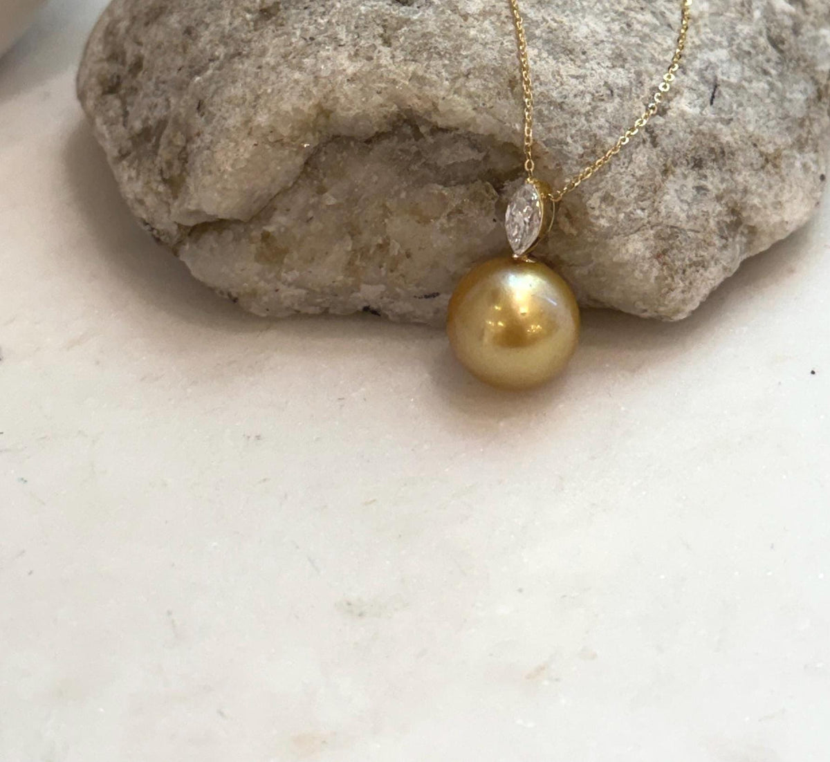 Genuine South Sea golden saltwater pearl pendant featuring deep tea gold color, mirror luster and marquise moissanite.