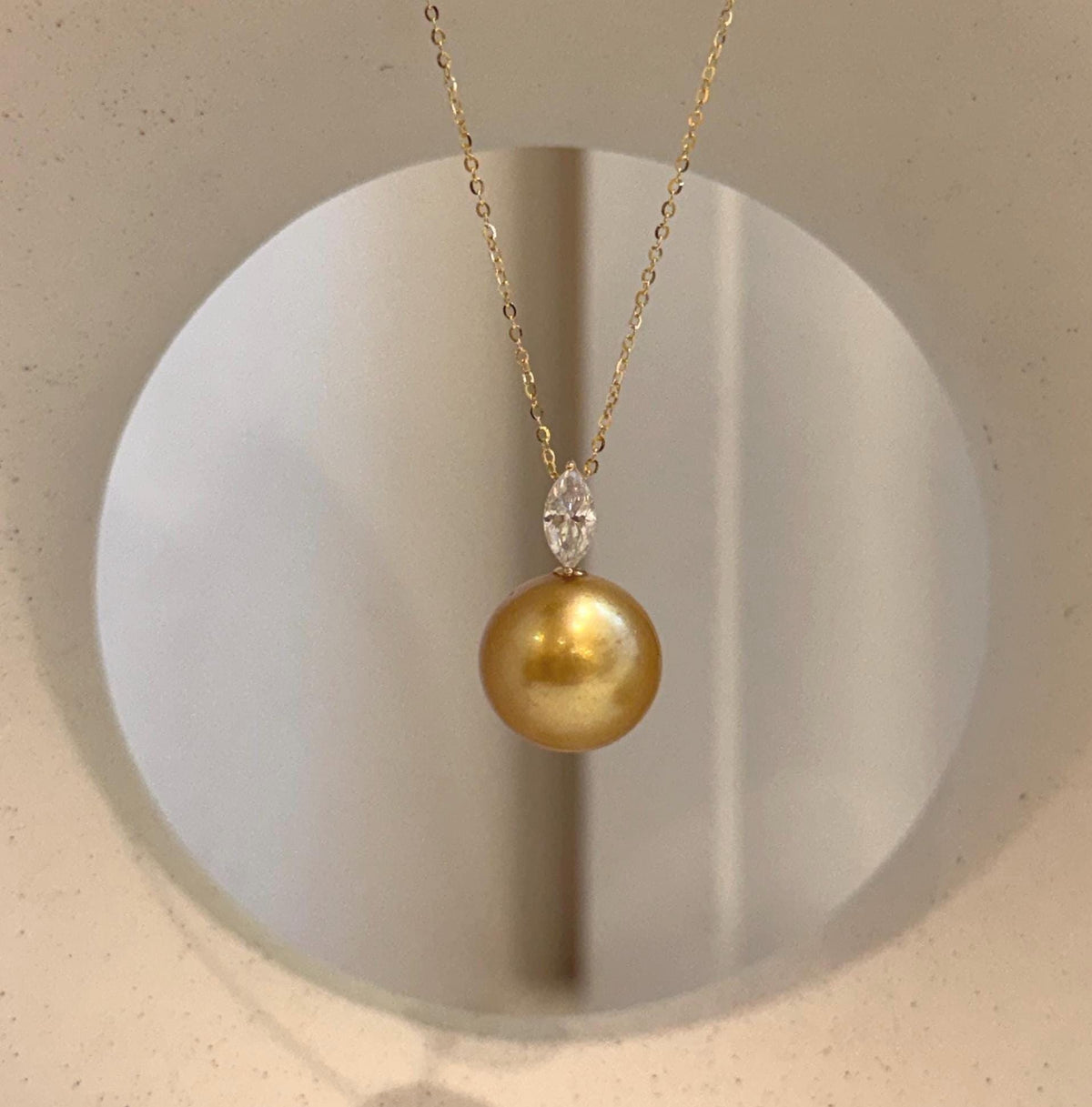 South Sea golden pearl pendant showcasing rich deep tea color with a sparkling marquise-shaped moissanite.