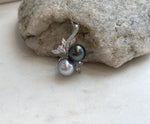 Natural Tahitian pearl jewelry with two lustrous 9.2–9.5mm ocean pearls in an elegant vertical pendant design.