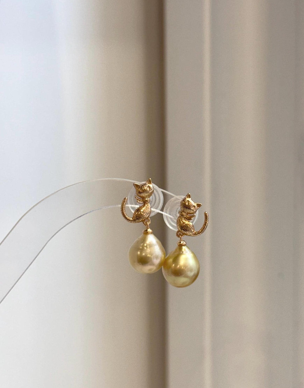 Cute cat earrings featuring genuine South Sea golden pearls with rich deep tea color and strong reflective luster.