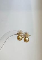 Luxury South Sea golden pearl earrings with elegant Art Deco styling and bright reflective luster.