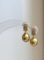 Luxury golden South Sea pearl earrings with sparkling geometric settings
