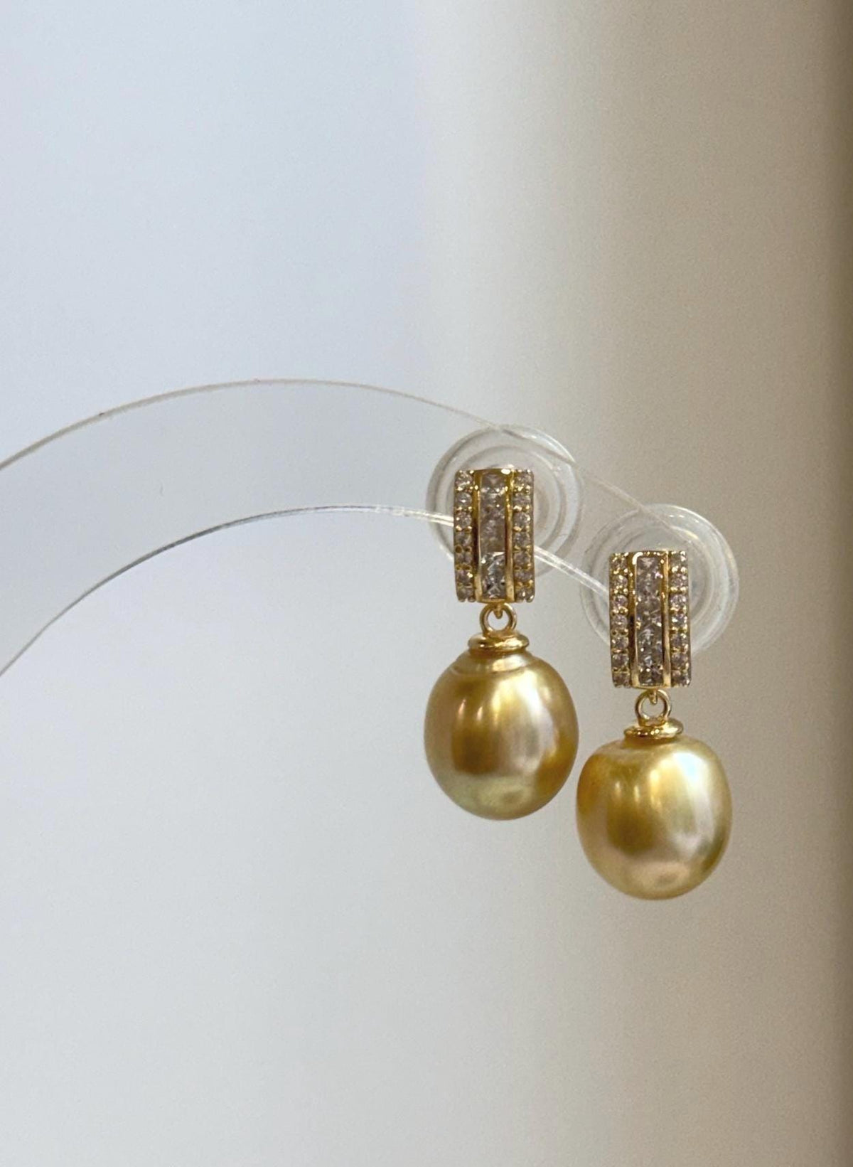 Luxury golden South Sea pearl earrings with sparkling geometric settings
