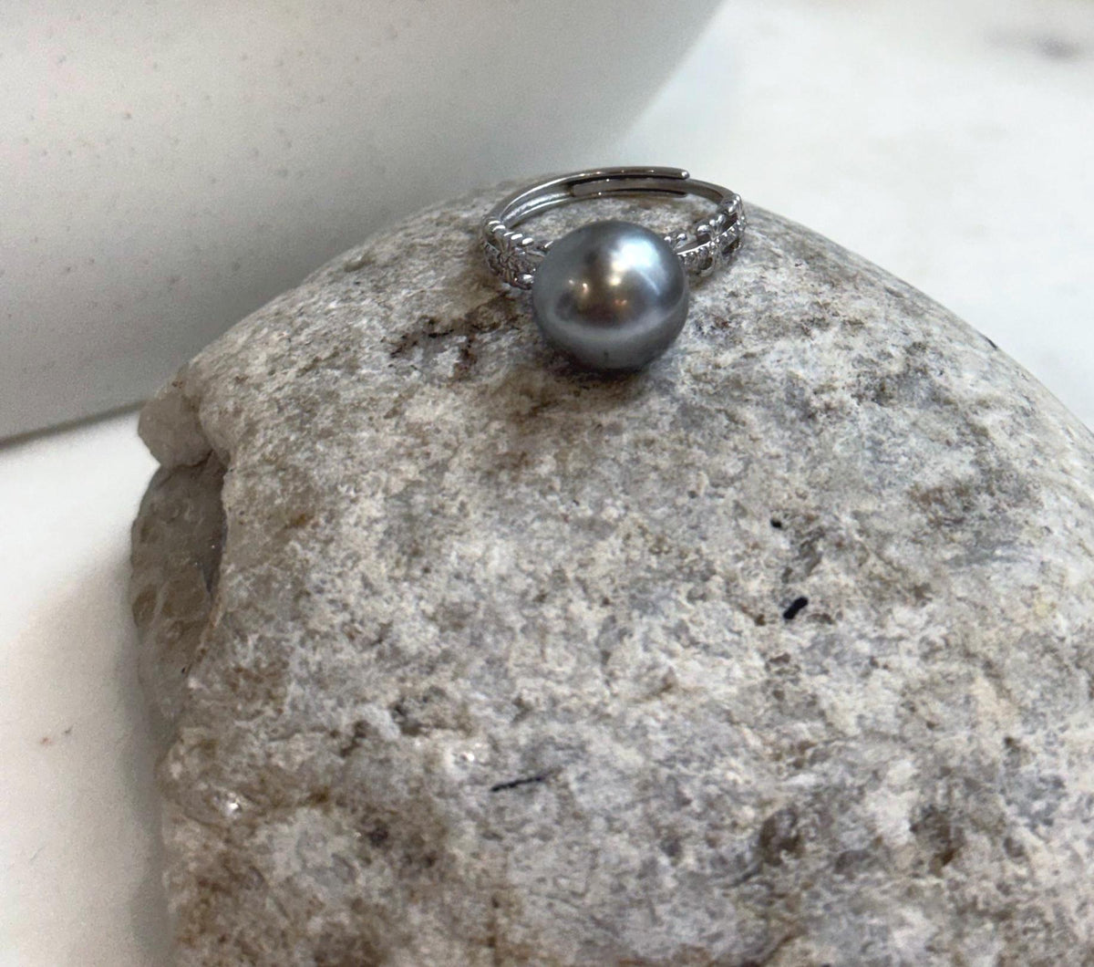 Genuine Tahitian saltwater pearl ring featuring beautiful platinum tone and brilliant reflective luster