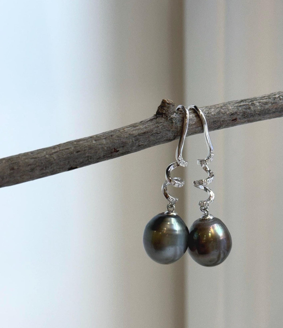 Tahitian platinum green pearl hook earrings with extreme mirror luster and elegant drop design