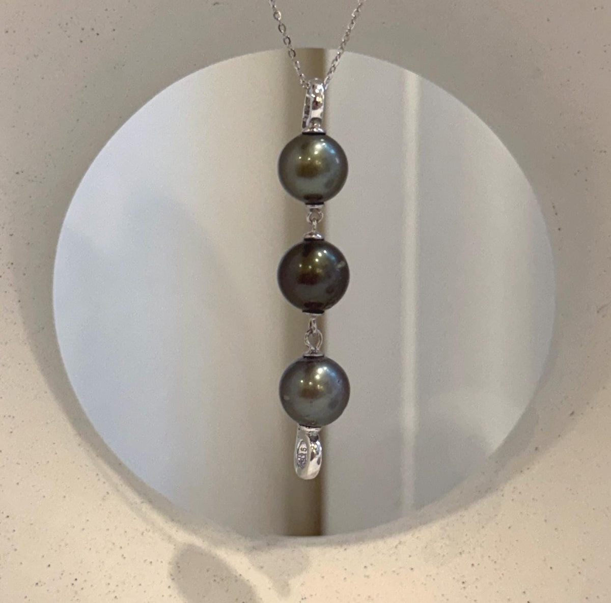 Tahitian pearl necklace extender featuring three luminous ocean pearls and sterling silver components.