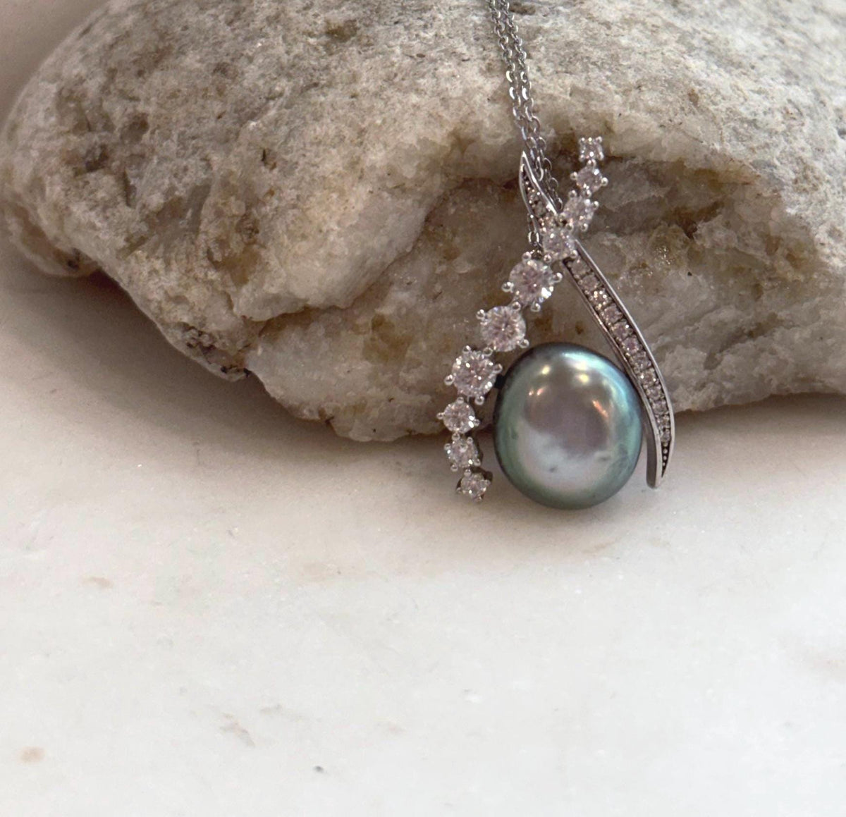 Genuine Tahitian ocean Keshi pearl pendant displaying rich peacock green iridescent color.