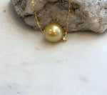 Large round deep golden South Sea pearl pendant with elegant minimalist design