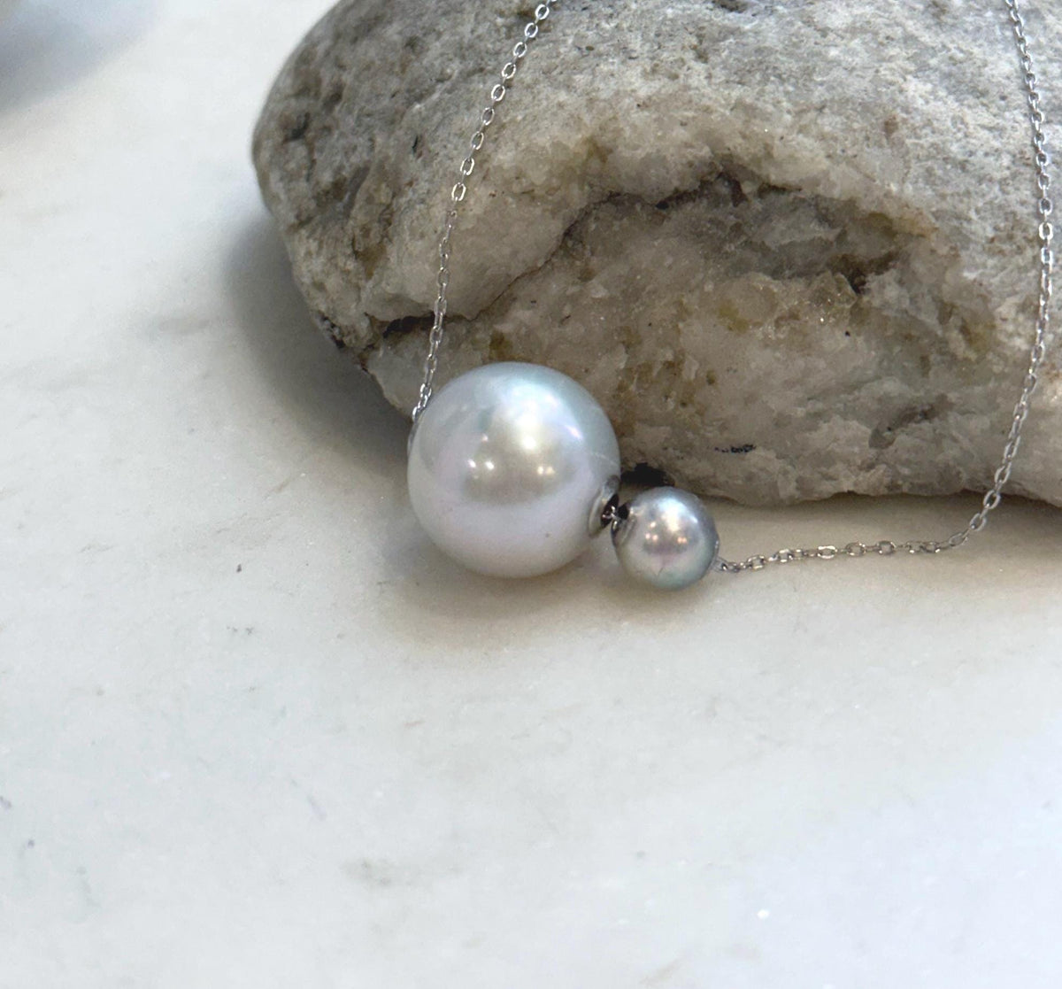 Double pearl floating pendant featuring Akoya and Edison pearls with 18K gold details