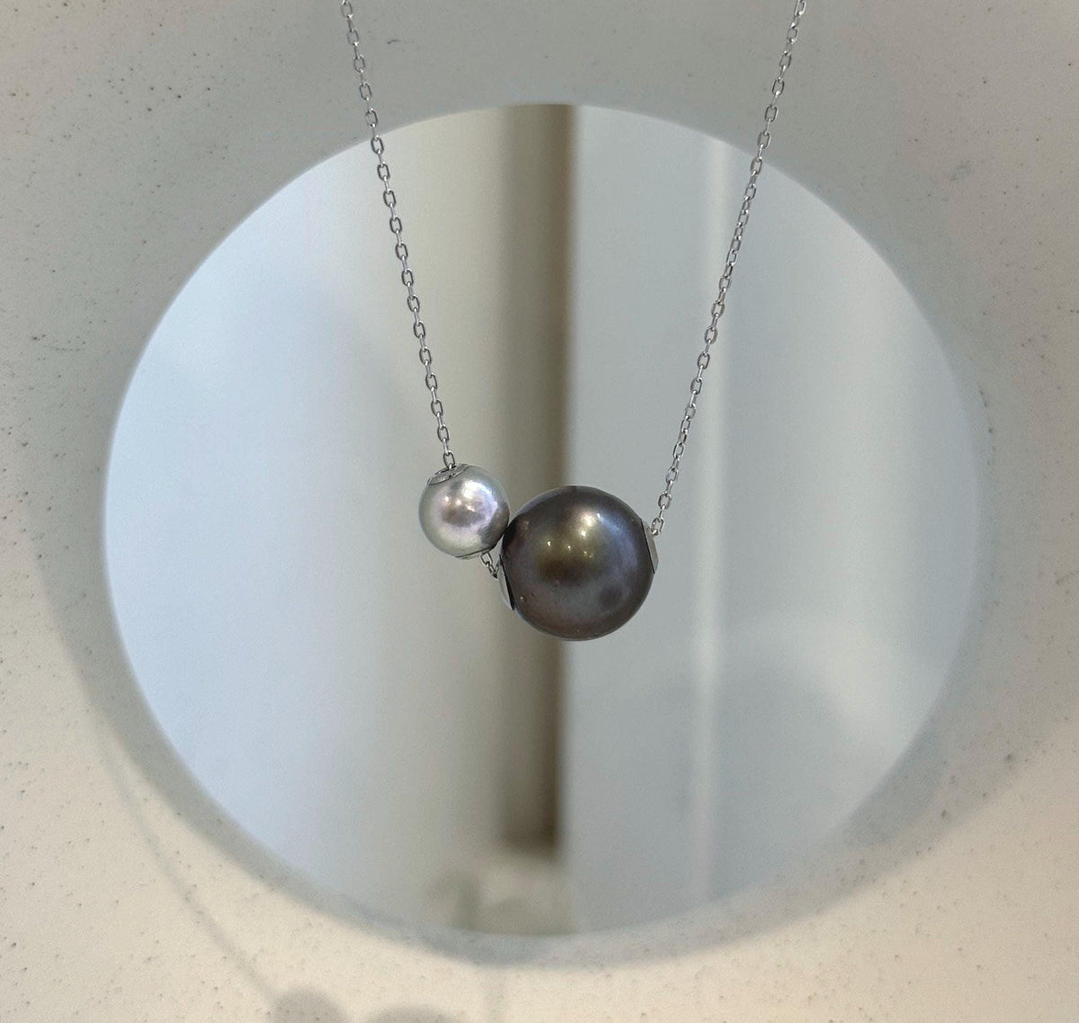 Luxury double ocean pearl floating necklace combining Tahitian and Akoya pearls with sterling silver chain