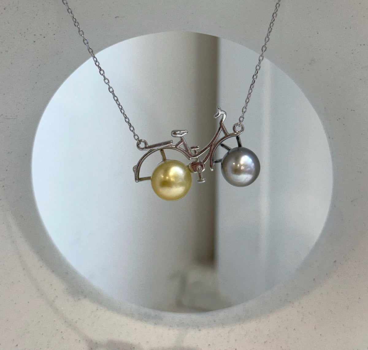 Unique bicycle necklace featuring two genuine ocean pearls and S925 silver.