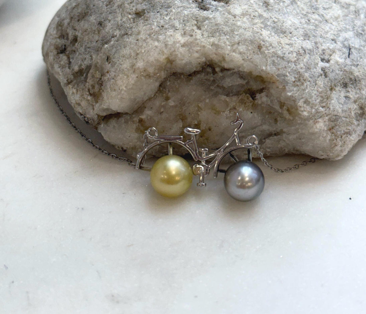 Tahitian platinum and golden pearl necklace with delicate bicycle design.