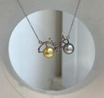 Double pearl bicycle pendant necklace with natural Tahitian and South Sea pearls.