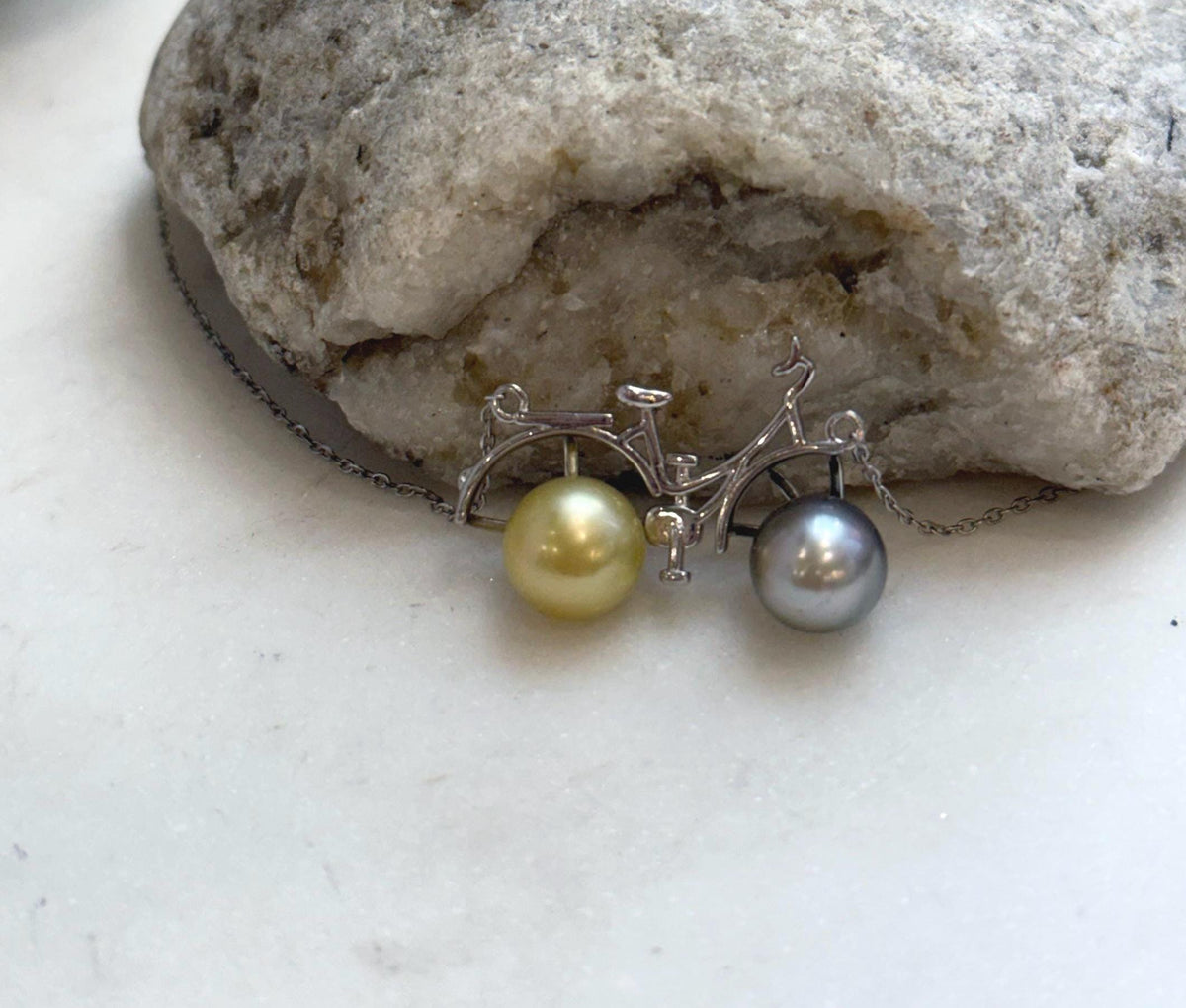 Elegant S925 silver bicycle necklace with platinum and golden ocean pearls.