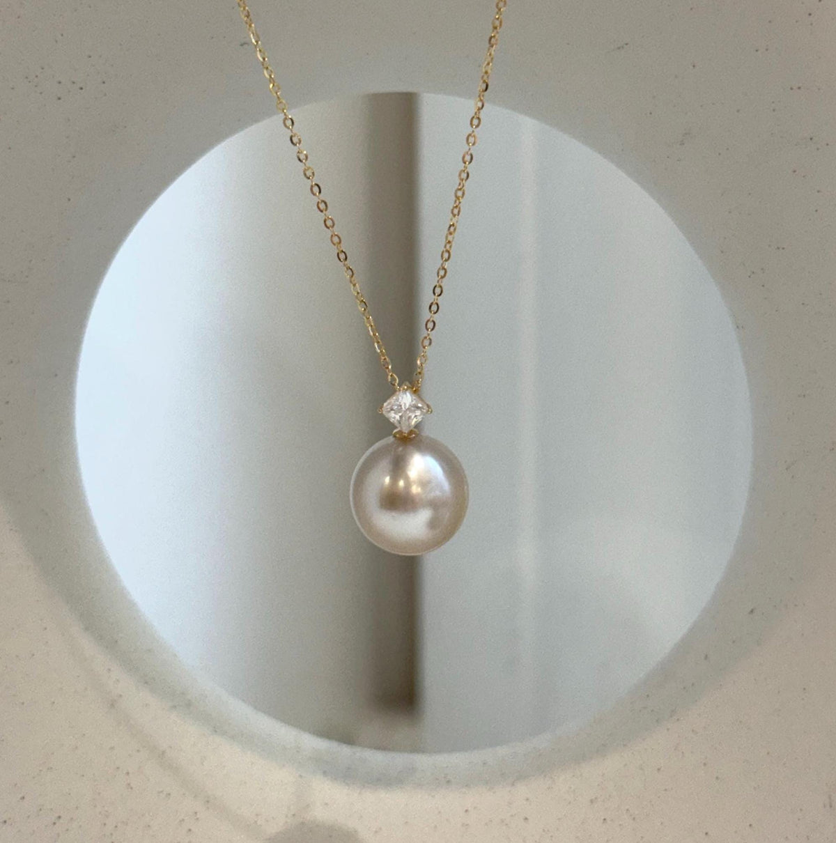 Genuine ocean pearl pendant featuring a champagne South Sea pearl and 18K gold.